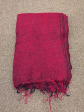 This maroon yak wool meditation shawl, handmade in Nepal by skilled artisans, provides warmth and comfort, enhancing your meditation practice and fostering a serene atmosphere for spiritual connection.