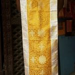 This handmade altar cloth, crafted by skilled artisans in Nepal, features a sacred lotus design, symbolizing purity and enlightenment, perfect for enhancing your meditation space.