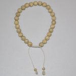 Handmade in Nepal by skilled artisans, this Lotus Seeds mala with 27 beads supports meditation and prayer, symbolizing the journey towards purity and enlightenment in Tibetan Buddhism.
