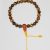 This handmade Tiger's Eye wrist mala from Nepal features 25 beads and a carnelian guru bead, offering grounding energy and protection for your spiritual journey and daily practices.