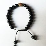 This handmade Black Onyx Hand Mala, crafted by skilled artisans in Nepal, supports meditation and travel while promoting peace, wisdom, and emotional balance on your spiritual path.