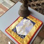 This handmade Tibetan white dorji placemat, crafted by skilled artisans in Nepal, enhances your meditation space while embodying the essence of Vajrayana teachings.