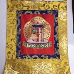 This handmade silk brocade Kalachakra wall hanging from Nepal features a lotus design, serving as a spiritual reminder of the profound teachings of Tibetan Buddhism.