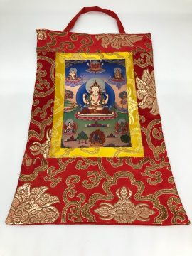 This handmade Chenrezig thangka wall hanging from Nepal embodies compassion and wisdom, beautifully encased in silk brocade, perfect for enriching your spiritual space.