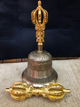 The 9 Pronged Bell and Dorje Set, handmade in Nepal by skilled artisans, symbolizes the union of method and wisdom, enhancing meditation with its profound sound and harmonious tones.