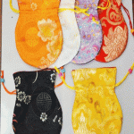 Handmade in Nepal by skilled artisans, these silk brocade mala bags protect your mala's spiritual essence and serve multiple purposes on your sacred journey.