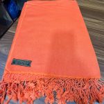 This vibrant orange shawl, made from 80% Pashmina and 20% silk, is handmade in Nepal by skilled artisans. It enhances meditation, offering warmth and focus for the practitioner.