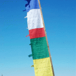 This handmade vertical prayer flag from Nepal features sacred symbols and prayers, inviting blessings and positive intentions into the world, fostering tranquility and spiritual connection.