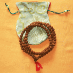 Rudraksha beads, sacred to Lord Shiva, are handmade in Nepal by skilled artisans. This mala serves as a powerful tool for meditation and spiritual growth.
