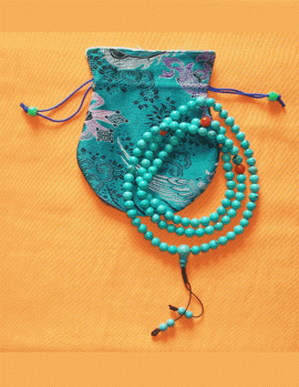 Handmade in Nepal by skilled artisans, these Tibetan Buddhist mala prayer beads feature turquoise and red coral, serving as sacred tools for meditation and spiritual growth.