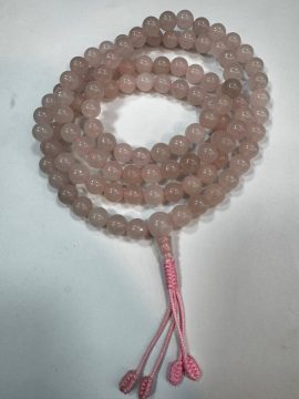 Handmade in Nepal by skilled artisans, these rose quartz mala beads support meditation, nurturing compassion and inner peace while enhancing the heart chakra's gentle energy.