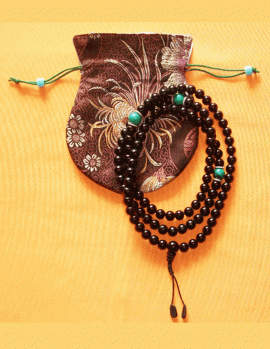 This handmade Black Onyx mala from Nepal, featuring 108 beads and three turquoise markers, supports meditation and emotional stability, guiding practitioners on their spiritual journey.