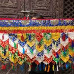 This handmade Lotus Design Tashi Tha-Ring Shambu Banner, crafted by skilled artisans in Nepal, invites the blessings of the Dharma into your sacred space.
