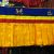 The Tibetan shambu, a handcrafted ruffled banner from Nepal, enhances sacred spaces with vibrant colors and eight auspicious symbols, inviting blessings and serenity into your home.