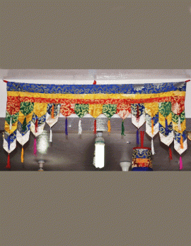 This handmade silk brocade door hanging from Nepal features a lotus design, symbolizing blessings and auspicious light, welcoming all with its vibrant colors and intricate craftsmanship.