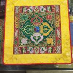 This handmade Tibetan altar cloth, adorned with a green double dorji and lotus, embodies wisdom and compassion. Crafted by skilled artisans in Nepal, it enhances your meditation space.