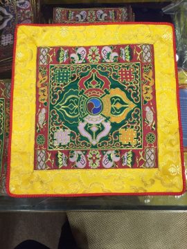 This handmade Tibetan altar cloth, adorned with a green double dorji and lotus, embodies wisdom and compassion. Crafted by skilled artisans in Nepal, it enhances your meditation space.