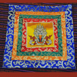 This handmade altar cloth, crafted in Nepal by skilled artisans, reflects the spiritual essence of Tibetan Buddhism, enriching your meditation space with tranquility and devotion.