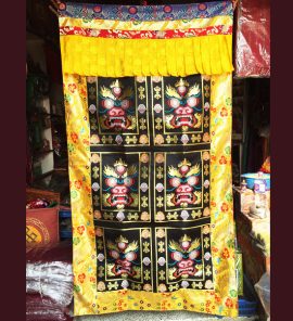 This handmade Tibetan door curtain, featuring a Mahakala design, is crafted in Nepal by skilled artisans, inviting blessings and protection into your sacred space.