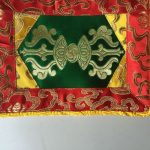 This handmade Green Dorje Placemat, crafted by skilled artisans in Nepal, enhances your spiritual space, inviting the essence of Vajrayana practice into your home with its traditional design.