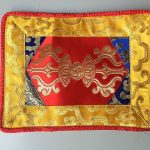 This handmade Red Dorji Placemat, crafted by skilled artisans in Nepal, symbolizes wisdom and compassion, enhancing your spiritual practice and serving as a sacred space for meditation.