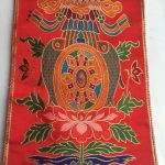 This handmade silk brocade table mat from Nepal features auspicious symbols, creating a sacred space for your bell and dorje during prayer and meditation.